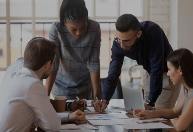 Colleagues collaborating at conference table.